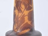 a vase that has a brown and yellow design on it