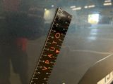 a close up of a ruler on the side of a car
