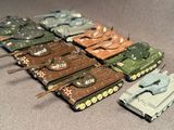 a lot of toy tanks that are sitting on a table