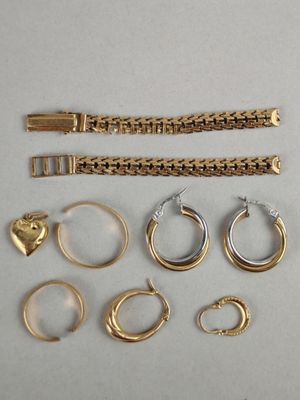 a lot of gold rings and bracelets on a table