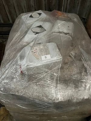 a toilet that is wrapped in plastic and sitting on a pallet