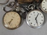 three clocks and a ball of yarn on the table