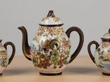 three different types of teapots sitting on a table