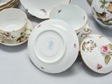 many plates and cups that are sitting on a table