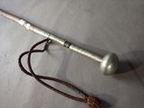 a cane with a handle and a rope on the ground