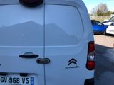 a white van parked in a parking lot next to other cars
