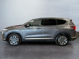 a silver suv parked in front of a white wall