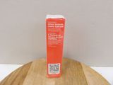 a box of toothpaste sitting on a wooden table