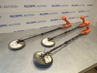 three metal detectors sitting on top of a table in front of a wall