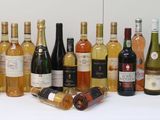 many bottles of wine that are lined up on the table