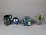 three vases and a pitcher sitting next to each other on a table