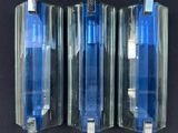 three blue pens sitting in a row on a black surface
