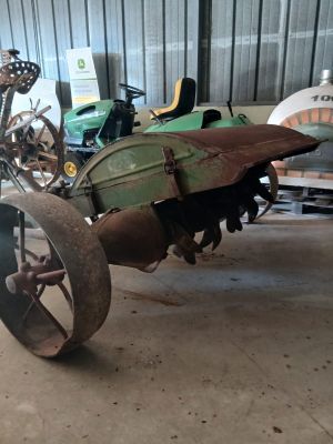a small tractor with a large tire in a garage