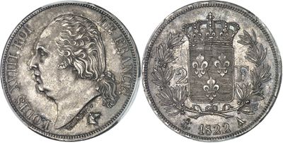 a silver coin with a crown on top of it