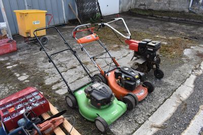 Plusieurs tondeuses à gazon sont alignées au bord de la route