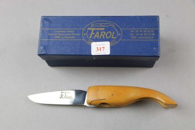 a knife that is sitting next to a box on a table