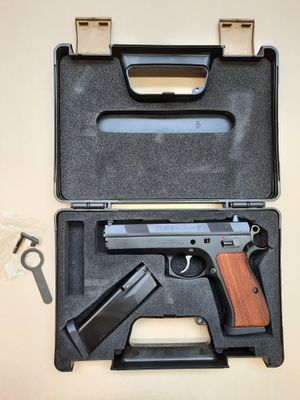 a gun in a case with a pair of scissors