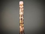 a tall glass vase with a pink and yellow design on it