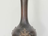 an antique bronze vase with a lion head on the top of it