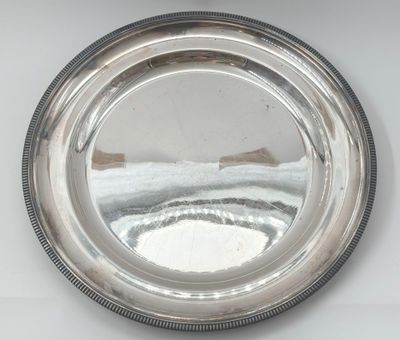 a silver plate with a mirror in the middle of it