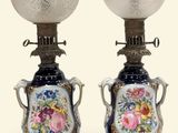 pair of blue and white vase lamps with floral designs on them