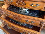 a dresser that has a lot of drawers on top of it