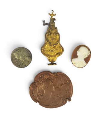 three pieces of gold and silver jewelry including a cameo, a cameo, and a cameo