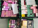 a green box filled with cosmetics and other beauty products