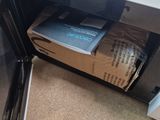 a microwave with a box of food inside of it