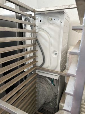 a washer and dryer inside of a metal cage