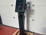 an image of a television on a stand in a garage