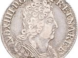 a silver coin with a woman ' s head and a crown on it