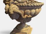 an image of a stone vase with a bird on it