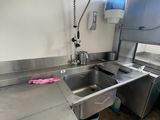 a kitchen with a sink and a dishwasher in it