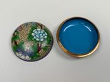 an image of a small box with a lid and a small container with a flower design on it