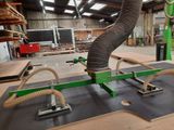 a machine that is working on a piece of wood