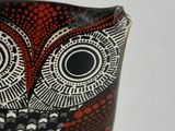a close up of an owl shaped bowl on a table