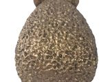 a small gold bear figurine sitting on a white surface