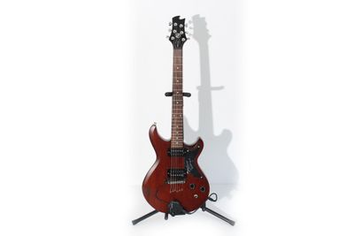 a red electric guitar sitting on top of a stand