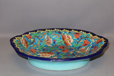 a blue bowl with a floral design on it