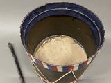 a small bucket with a pencil next to it on a table
