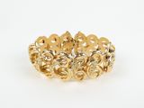 a gold bracelet with a flower design on it