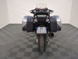 a motorcycle that is parked in a room with a checkered floor