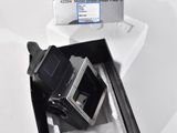 a black and white photo of a camera in a box