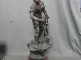 a statue of a man standing on top of a wooden base