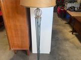 a lamp that is sitting on a stand in a room