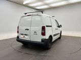 the white van is parked in a large room with a black floor