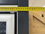 a measuring tape on the wall next to a refrigerator