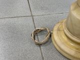 un anneau posé par terre près d'un pilier