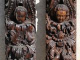 two pieces of wood with carvings on them on a wall